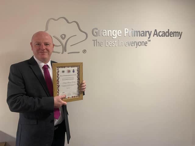 Chris Latimer, Grange Primary Academy headteacher, with award