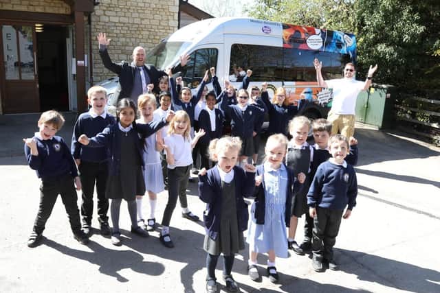 Head teacher Richard Albert with parent Alex Murphy who donated the minibus to the school