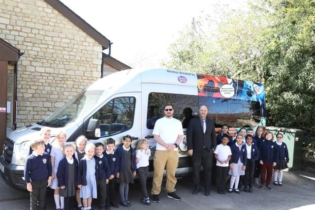 Mr Murphy with some of the pupils and Mr Albert with the minibus