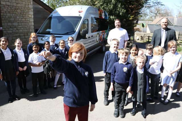 Eleven-year-old James Stear with the keys to the minibus.