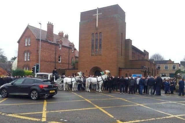 Mourners outside the church.