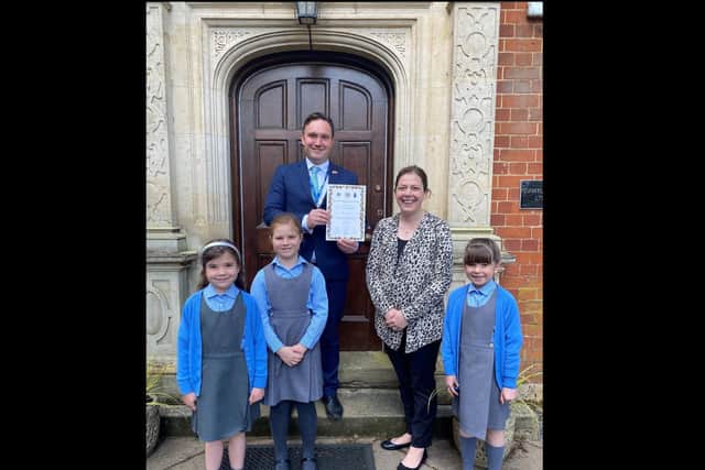 Headteacher Mark Thomas, music teacher Carly Palmer and some of the pupils with the Rose of Northamptonshire Award