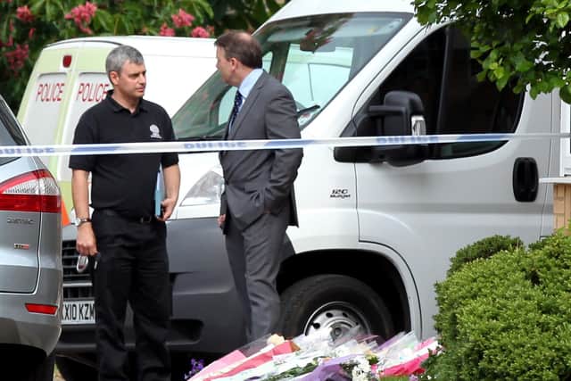 Locals left flowers outside the Dings' house while the police investigation continued