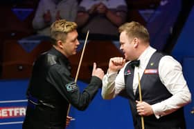 Kettering's Kyren Wilson congratulates former Irthlingborough man Shaun Murphy after the latter fought back to win 17-12 in their World Championship semi-final clash at the Crucible. Picture courtesy of Getty Images