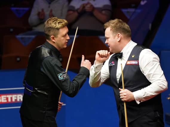 Kettering's Kyren Wilson congratulates former Irthlingborough man Shaun Murphy after the latter fought back to win 17-12 in their World Championship semi-final clash at the Crucible. Picture courtesy of Getty Images
