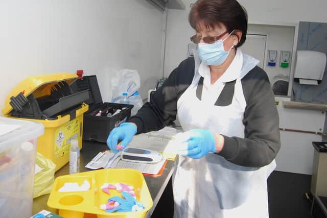 Healthcare Assistant Kate Varnfield preparing tests inside the fast food trailer
headquarters.