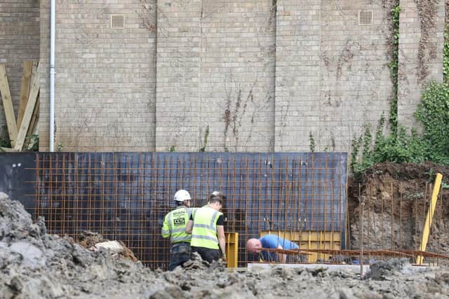 The retaining wall is being built at the other side of the hall wall