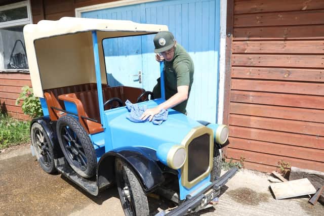 Elliot Lewer polishes one of 'Mr Wicksteed's cars
