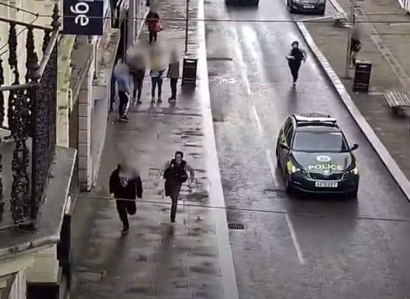 PC Gardner chases Griffin past startled onlookers in Gold Street