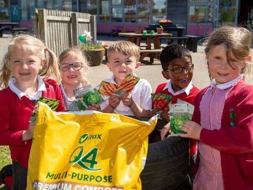 Students at Oakley Vale Primary School with the seeds and compost donated by Barratt Homes