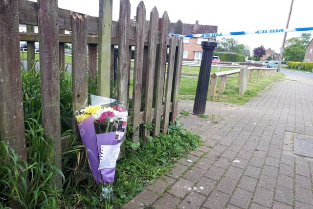 A police officer moving flowers.