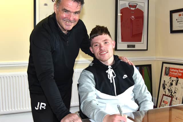 Jordon Crawford, who left Corby Town last week, puts the finishing touches to his move to Kettering Town alongside Poppies assistant-manager John Ramshaw. Picture courtesy of Paul Cooke/Poppies Media