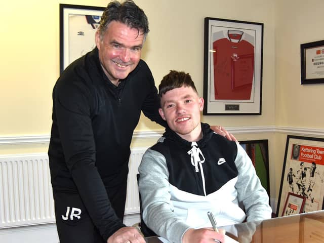 Jordon Crawford, who left Corby Town last week, puts the finishing touches to his move to Kettering Town alongside Poppies assistant-manager John Ramshaw. Picture courtesy of Paul Cooke/Poppies Media