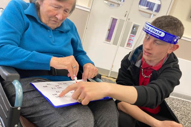 Kai from Isebrook School, Kettering, volunteering in the day centre