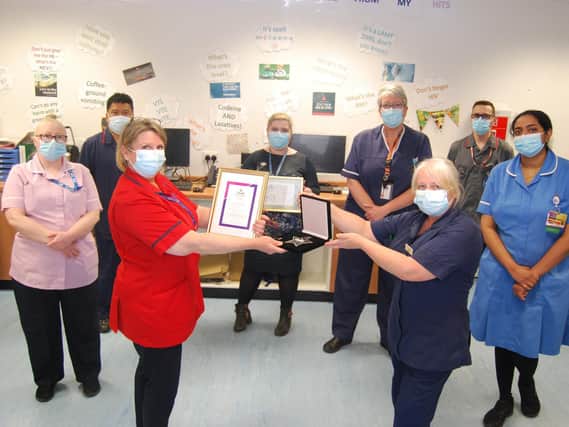 The Digestive Diseases Unit team are presented with their award by Head of Clinical Operations Jo Sturgess (L) to DDU Ward Sister Angie Robinson.