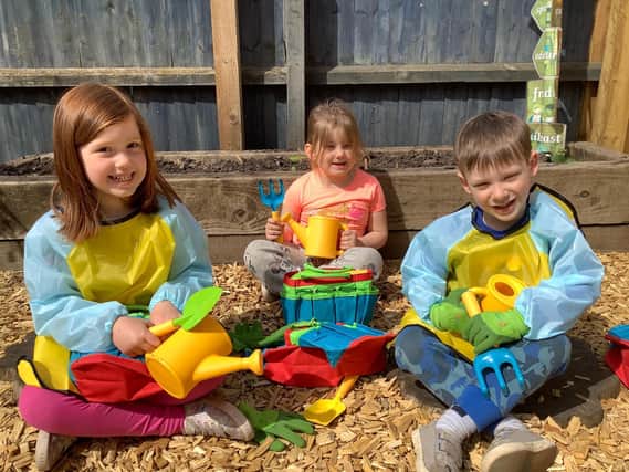 Children at Crazy4Kids nursery in Thrapston with their gardening equipment donated by David Wilson Homes