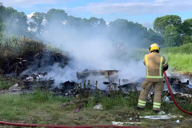 Firefighters had to hose down a pile of burning waste two times in one evening.