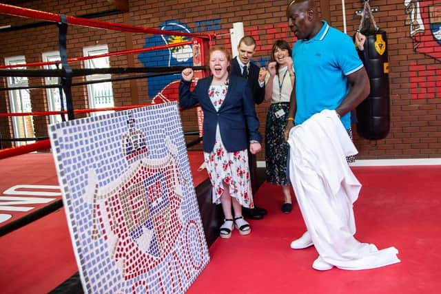 Frank Bruno unveils Isebrook School's mosaic with pupils and teachers at The Round by Round Centre in Northampton