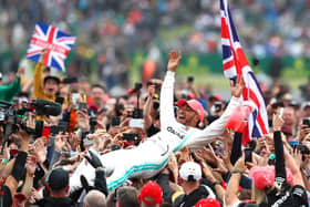 Lewis Hamilton celebrates his Silverstone victory in 2019 by crown-surfing