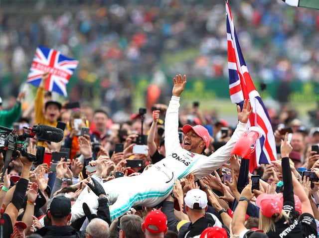 Lewis Hamilton celebrates his Silverstone victory in 2019 by crown-surfing