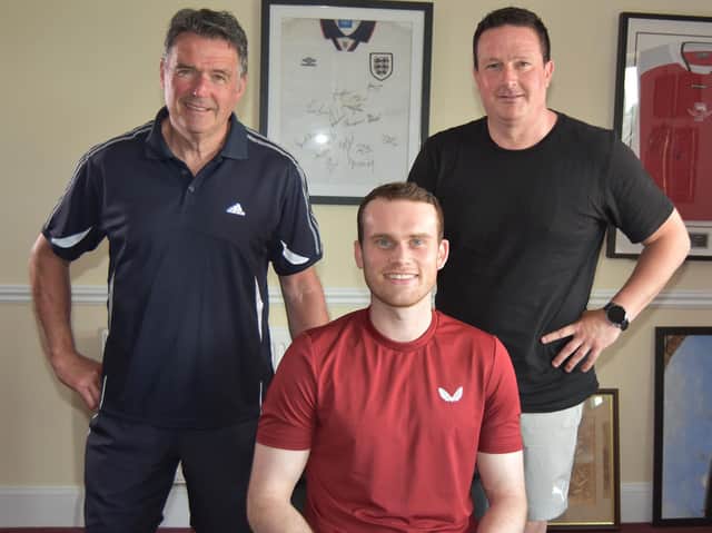 Central defender Chris Smith signed for Kettering Town under the watchful eyes of manager Paul Cox and assistant-boss John Ramshaw. Picture courtesy of Poppies Media