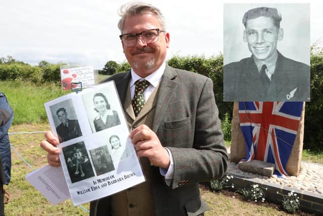 James Pogson with a photo of his grandfather Flight Sergeant William Brown DSO