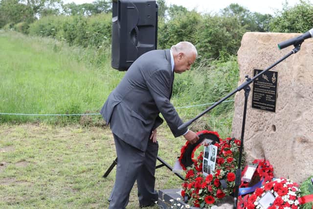 Lindsay Alvis lays a wreath at the memorial