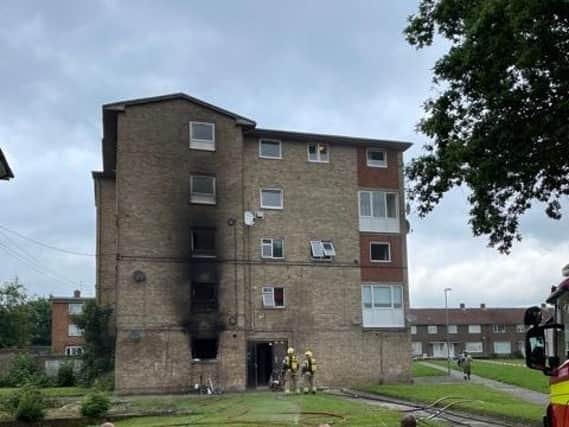 The block of flats shows smoke damage on the outside