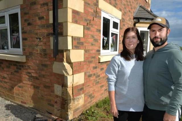 Katie and Jack Walther with their damaged home. Image: Andrew Carpenter.