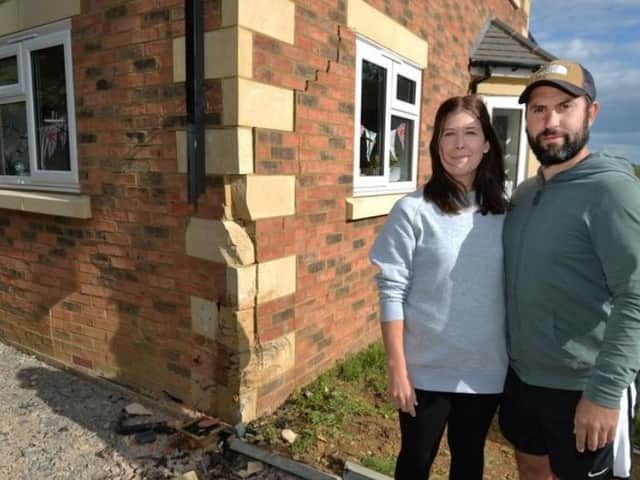 Katie and Jack Walther with their damaged home. Image: Andrew Carpenter.
