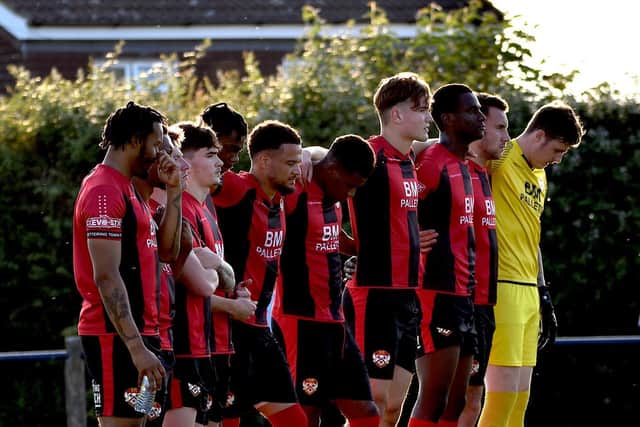The Kettering Town players observed a minute's silence in memory of former striker and assistant-manager Ernie Moss ahead of last night's friendly at Cogenhoe United. Pictures courtesy of Poppies Media