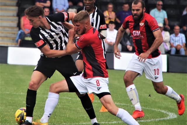 Corby Town's Jude Brittain grapples with former Steelman Connor Kennedy during the 1-1 draw with Kettering Town at Steel Park. Picture by David Tilley