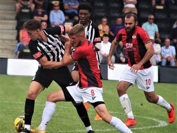 Corby Town's Jude Brittain grapples with former Steelman Connor Kennedy during the 1-1 draw with Kettering Town at Steel Park. Picture by David Tilley