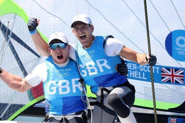 Dylan Fletcher (right) and Stuart Bithell celebrate winning gold in the Men's Skiff 49er class medal race in Tokyo. Picture by Phil Walter/Getty Images