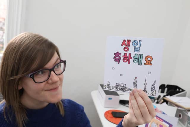 Charlotte with one of her Korean-inspired greetings cards