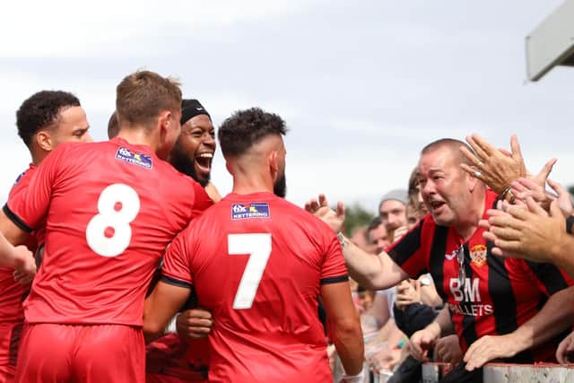 The Kettering Town players and fans celebrate after Claudio Ofosu scored what proved to be the winning goal from the penalty spot on the opening day of the season. Pictures by Peter Short