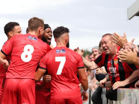 The Kettering Town players and fans celebrate after Claudio Ofosu scored what proved to be the winning goal from the penalty spot on the opening day of the season. Pictures by Peter Short