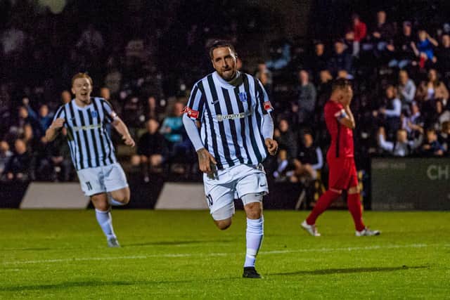 Steve Diggin heads off to celebrate after he scored Corby Town's second goal in their 2-0 win over Wisbech Town. Pictures by Jim Darrah