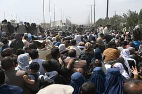 Many hundreds of Afghans are waiting at Kabul airport. Image: Getty.