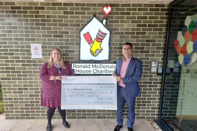Franchisee Perry Akhtar presenting the cheque to Ronald McDonald House Charities.
