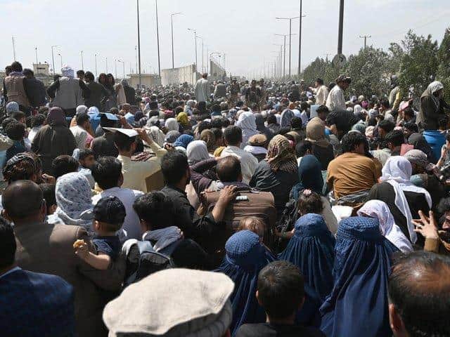 Afghans waiting at Kabul airport. Credit: Getty