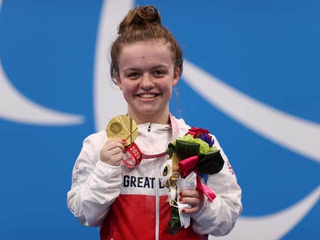 A delighted Maisie Summers-Newton shows off her Paralympic gold medal won in Tokyo on Thursday morning
