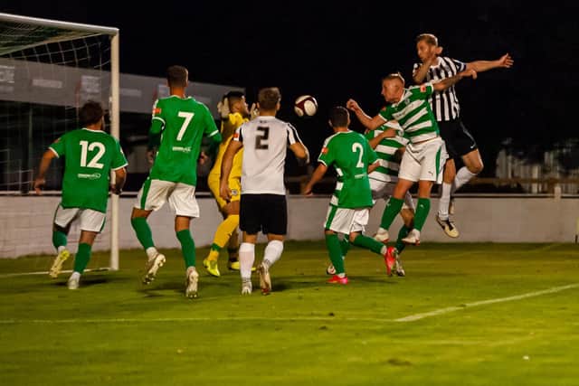 Gary Mulligan heads home his and Corby Town's second goal during their FA Cup win at Soham Town Rangers on Tuesday night. Picture by Jim Darrah