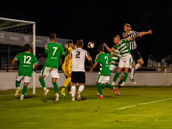 Gary Mulligan heads home his and Corby Town's second goal during their FA Cup win at Soham Town Rangers on Tuesday night. Picture by Jim Darrah