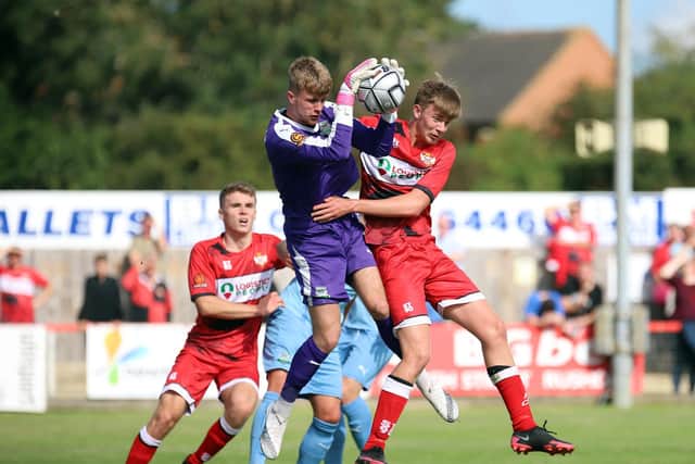 Isaac Stones challenges Farsley goalkeeper Thomas Donaghy