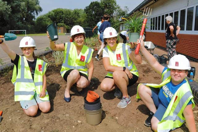 Pupils Lyra Norman and Alfie Line with Linda Stevens (left) from Davidsons Homes and Rushden Academy teacher Cassie Wiles.