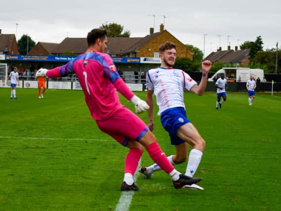 Will Jones challenges Peterborough Sports goalkeeper Lewis Moat during AFC Rushden & Diamonds' 1-0 defeat on Bank Holiday Monday. Picture courtesy of Hawkins Images