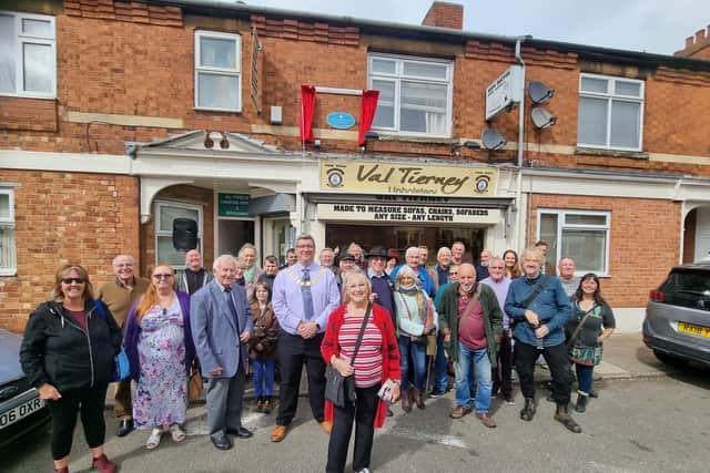 Mavis Tompkins with the Mayor of Kettering Cllr Scott Edwards and guests outside the shop in Regent Street where Derek Tompkins opened his shop