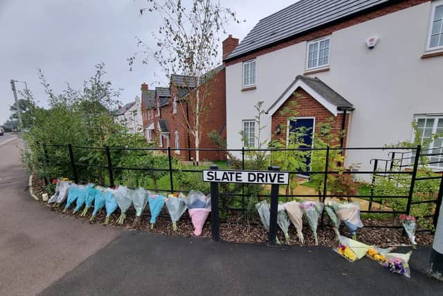 Flowers left outside the Slate Drive home.