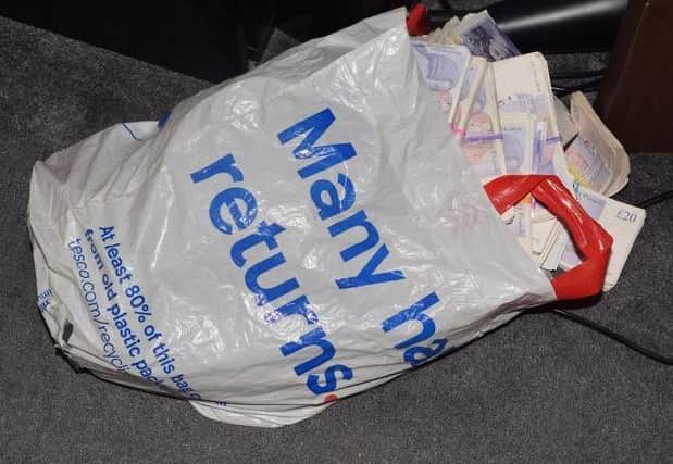 Police found thousands of pounds stuffed into a Tesco carrier bag